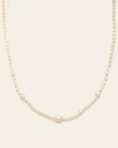 Delicate freshwater pearl necklace with subtle size variation and gold vermeil accents.
