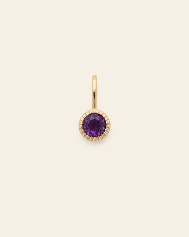 10k solid gold amethyst birthstone pendant charm with round faceted purple gemstone in a minimalist fine jewelry design
