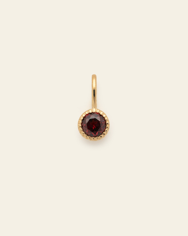 10k solid gold garnet birthstone pendant charm with round faceted red gemstone in a minimalist fine jewelry design