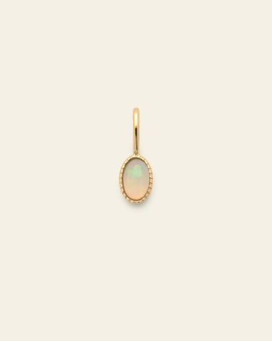 10k solid gold opal birthstone pendant charm with oval faceted iridescent gemstone in a minimalist fine jewelry design