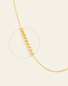 A magnified close up of gold vermeil box chain.