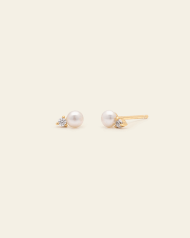 Hero Image of pair of fresh water pearl studs earrings with gold vermeil settings on a light beige background.