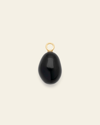 Hero Image of gold vermeil black agate pendant on cream background – natural dark stone charm, elegant fine jewelry accessory.