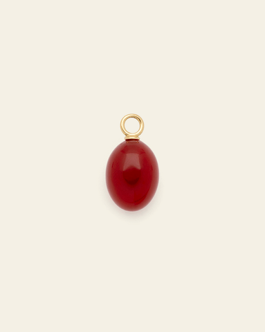 Hero Image of gold vermeil Red Agate charm on cream background – natural red stone stone, elegant fine jewelry accessory.