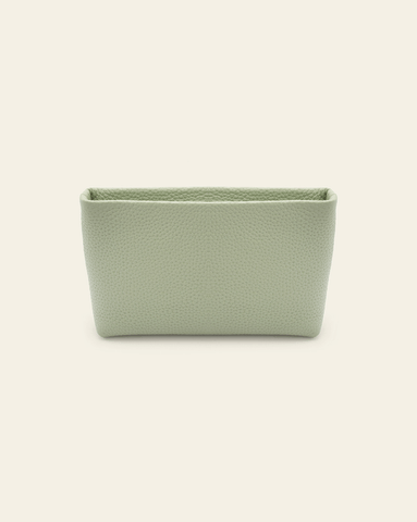 Hero image of Petite Essentials leather Pouch in Pistachio pebbled leather on cream background. 