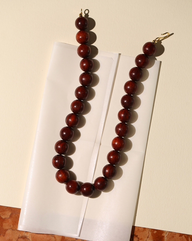 Picture of the 15mm Medium Boule Necklace that showcase the S hook in Gold Vermeil on a cream background.