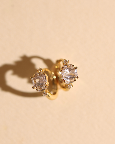 Gold hoop earrings with emerald cut cubic zirconia stones and pavé accents