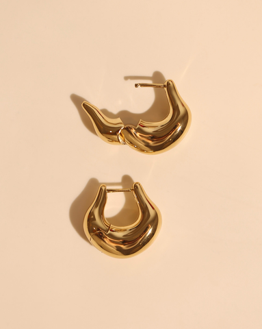 Gold chunky hoop earrings with sculptural wave design and high-polish finish - bold statement jewelry.