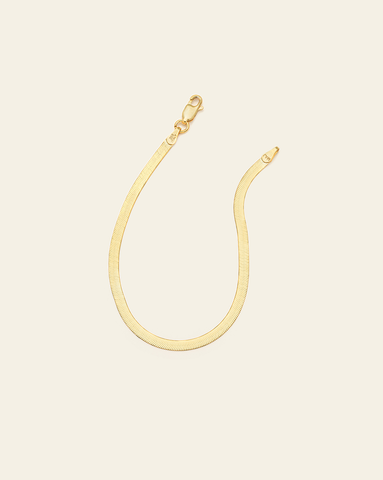 Gold Vermeil herringbone bracelet with flat, reflective links and a smooth finish. 
