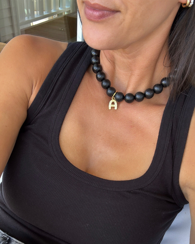 Model is wearing the 15mm Dark Boulé Necklace with an gold vermeil AlphaBet initial A attached with a gold vermeil XL Charm Clasp.