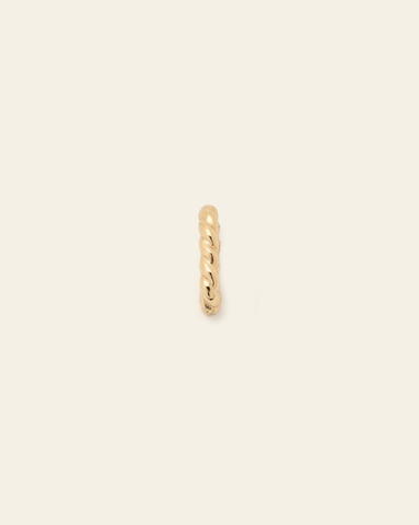 hero image of gold vermeil woven charm clasp on cream background.