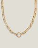 Bold gold-plated statement Figaro link necklace with circle clasp closure.