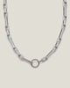 Bold rhodium-plated statement link necklace with circle clasp closure.